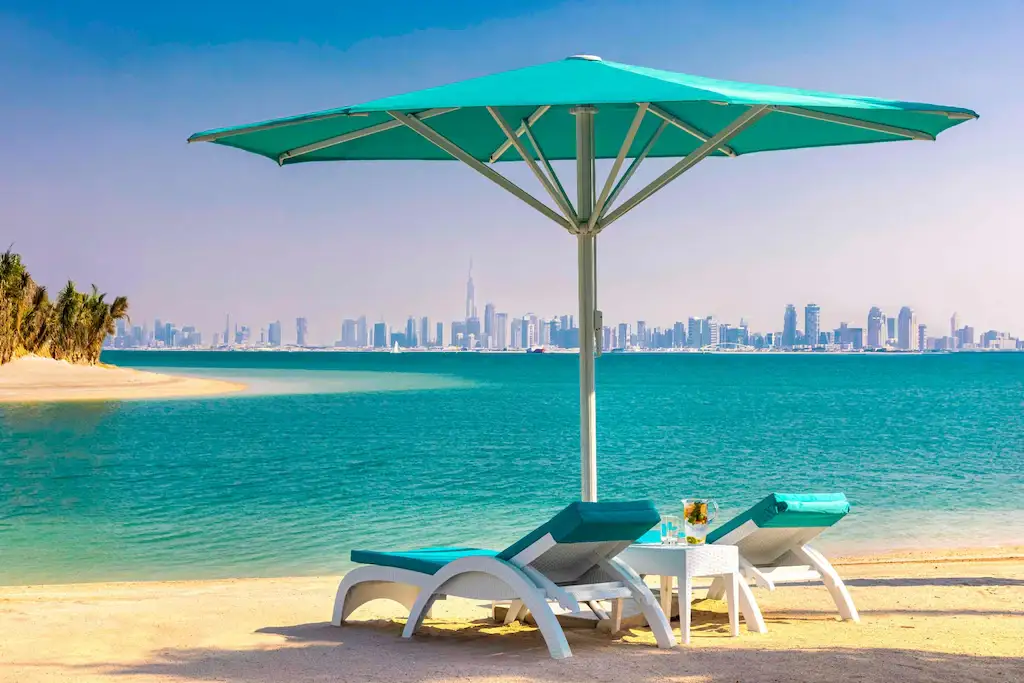 Private beach at Anantara World Islands Dubai Resort with the Dubai skyline
